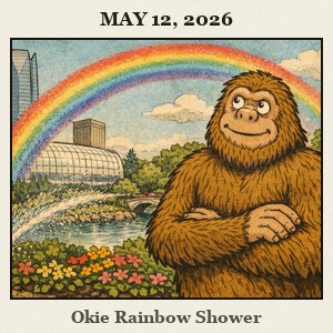 Furry Bigfoot in the Myriad Gardens near a sprinkler spraying water, forming a rainbow over him.