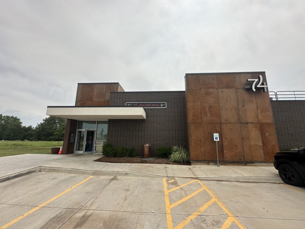 Exterior of 74 Sports Kitchen and Cocktails in Oklahoma City with the 74 sign on the building