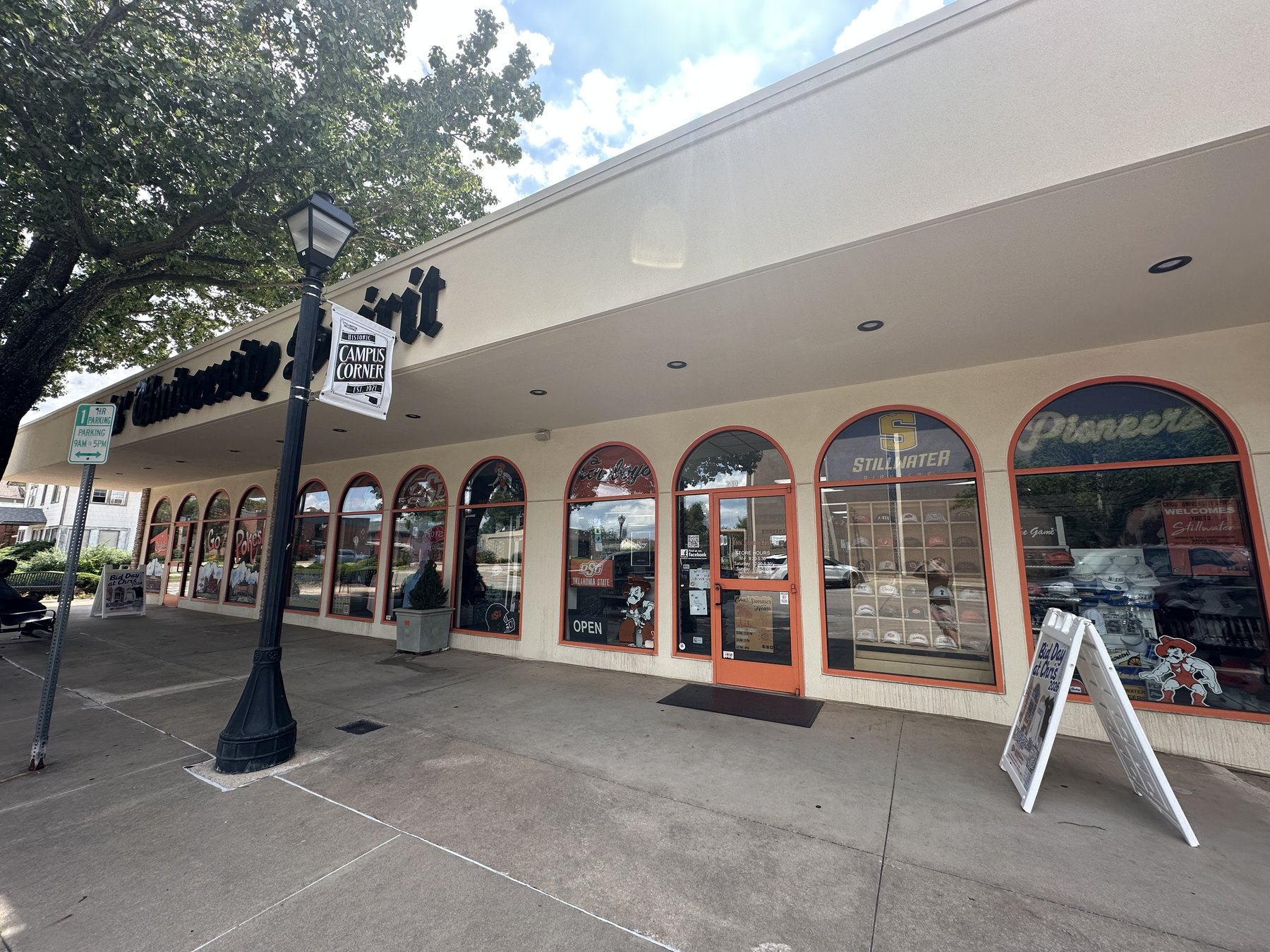Exterior of Chris' University Spirit in Stillwater, Oklahoma, with OSU merchandise visible in the storefront windows.
