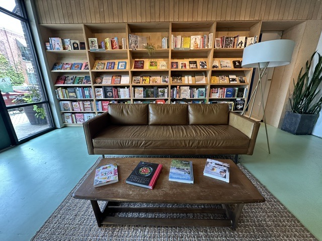 Leather sofa and coffee table in front of bookshelves inside Commonplace Books in Midtown OKC.
