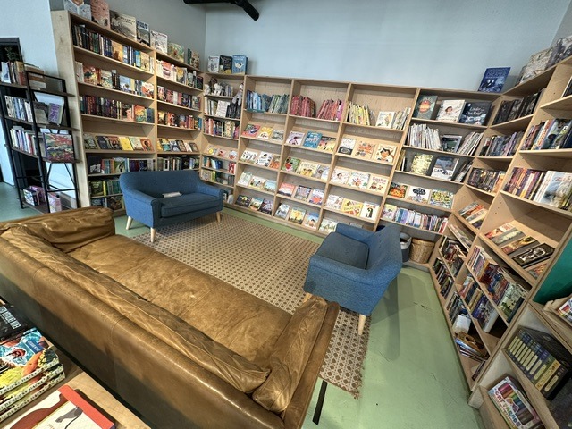 Wide view of bookshelves and comfortable chairs inside Commonplace Books in Midtown OKC.
