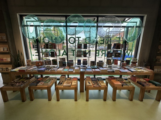 Book display tables by the front window inside Commonplace Books in Midtown OKC.