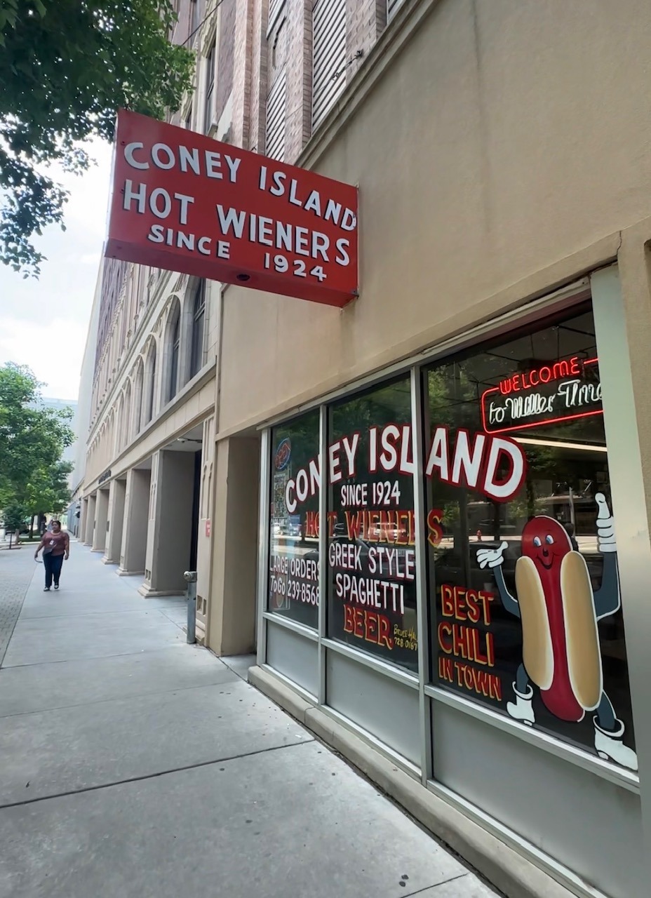 Exterior of Coney Island Downtown OKC with a red sign reading Coney Island Hot Wieners Since 1924.