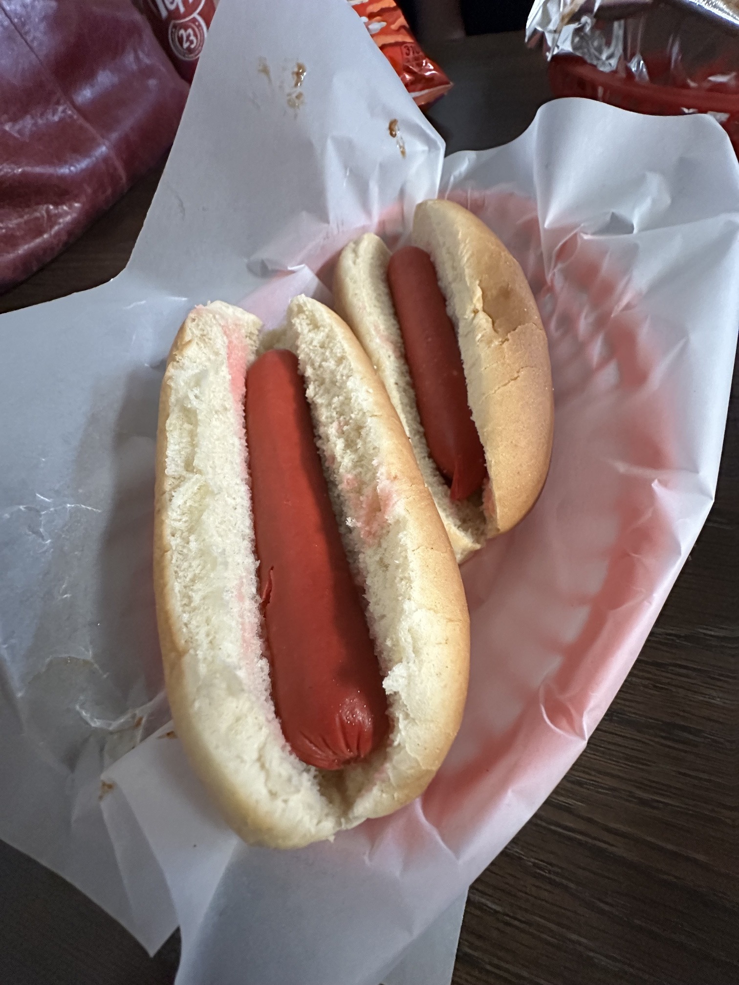 Two plain hot dogs in buns served on paper at Coney Island Downtown OKC.