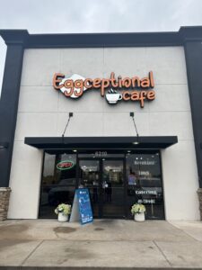 Front entrance of Eggceptional Cafe in Oklahoma City with the cafe's sign above the door.