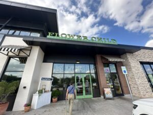 Exterior of Flower Child in Oklahoma City with green signage above the entrance.