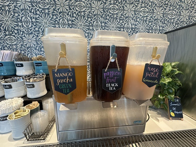Drink station at Flower Child with mango green tea, passion fruit black tea, and rose petal lemonade.