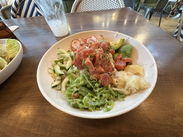 Fresh tuna bowl at Flower Child with avocado, radishes, cucumber, greens, and lime.