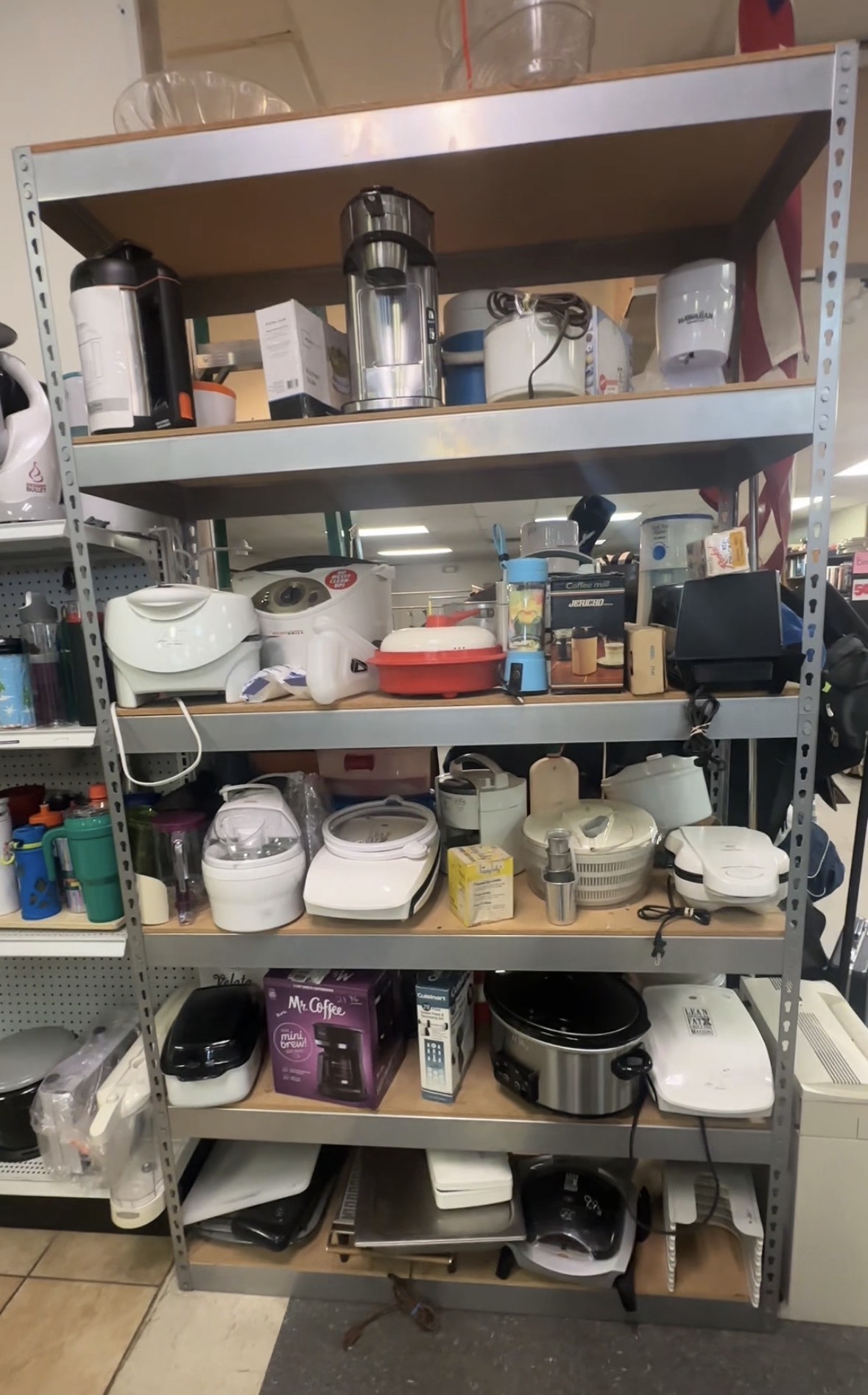 Shelves of small appliances and kitchen items at Friendly Thrift Store in Oklahoma City.