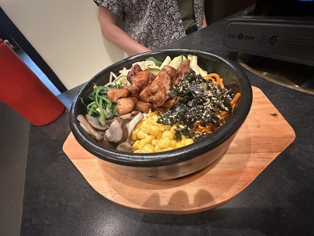 Hot stone bibimbap-style bowl with chicken and vegetables at Mr. Kimchi Korean Bistro in Oklahoma City.