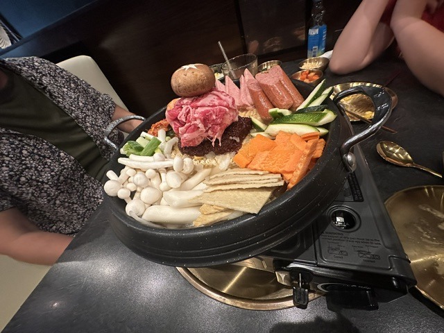 Korean barbecue platter with meats, mushrooms, vegetables, and fish cakes at Mr. Kimchi Korean Bistro.