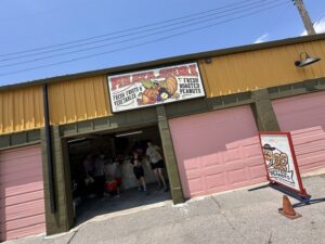 Exterior of Pinata Store near the Oklahoma City Farmers Market with a sign for fresh fruits, vegetables, and roasted peanuts