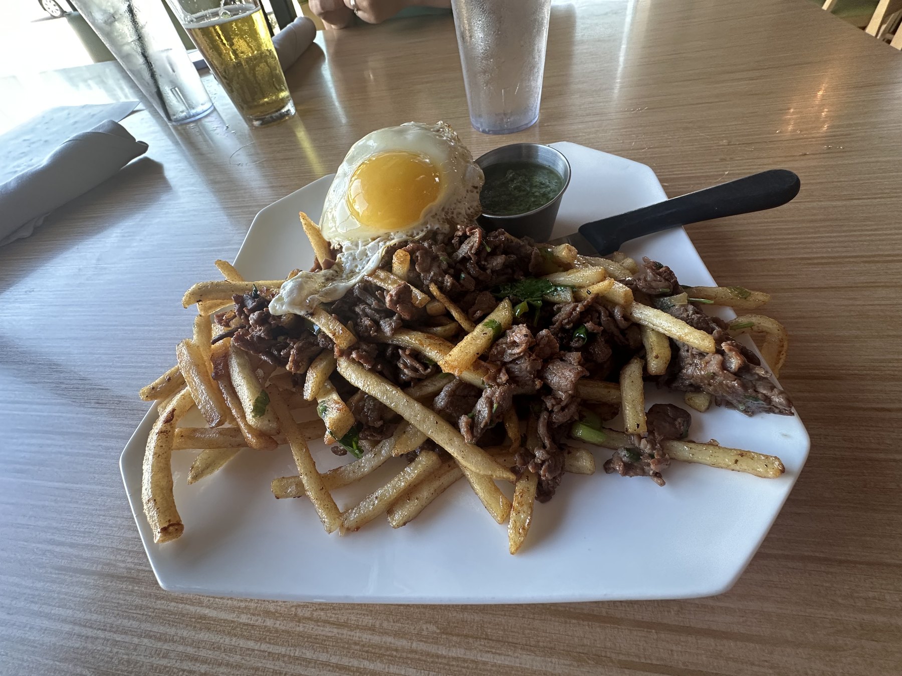 Gangnam style fries topped with bulgogi beef, scallions, sauce, and a fried egg at Riviere Modern Banh Mi in OKC.