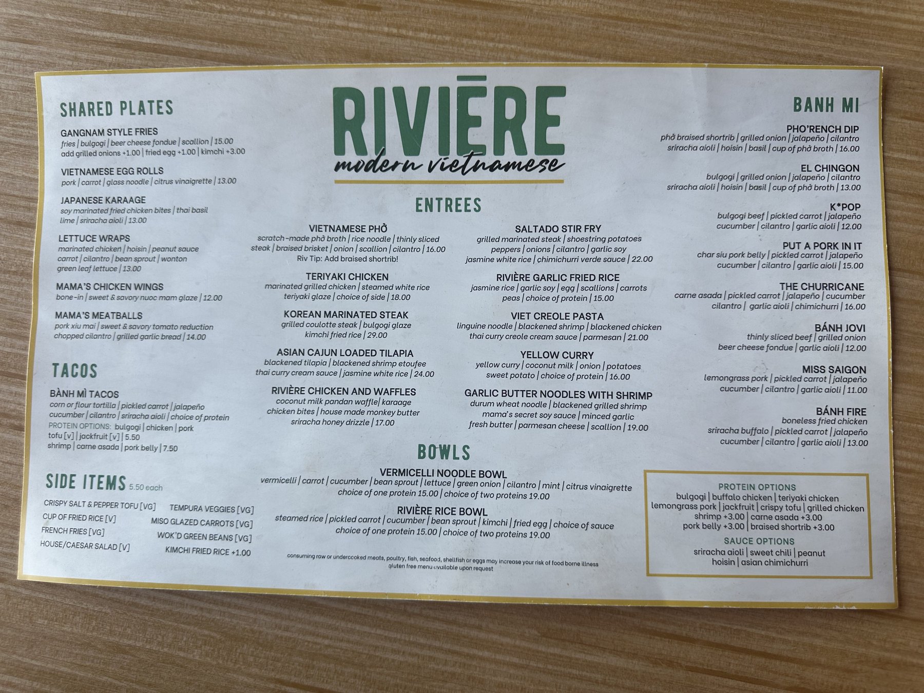 Food menu at Riviere Modern Vietnamese in Oklahoma City showing shared plates, entrees, bowls, tacos, and bánh mì options.