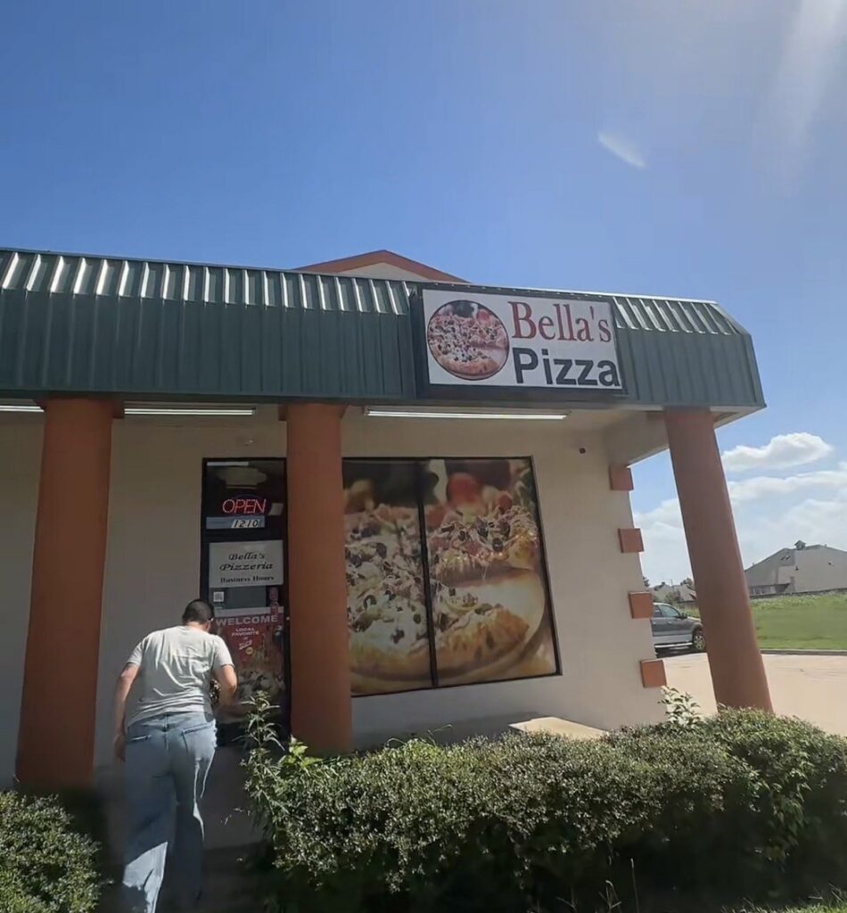 Exterior of Bella’s Pizza in Moore, Oklahoma, with the storefront sign above the entrance.