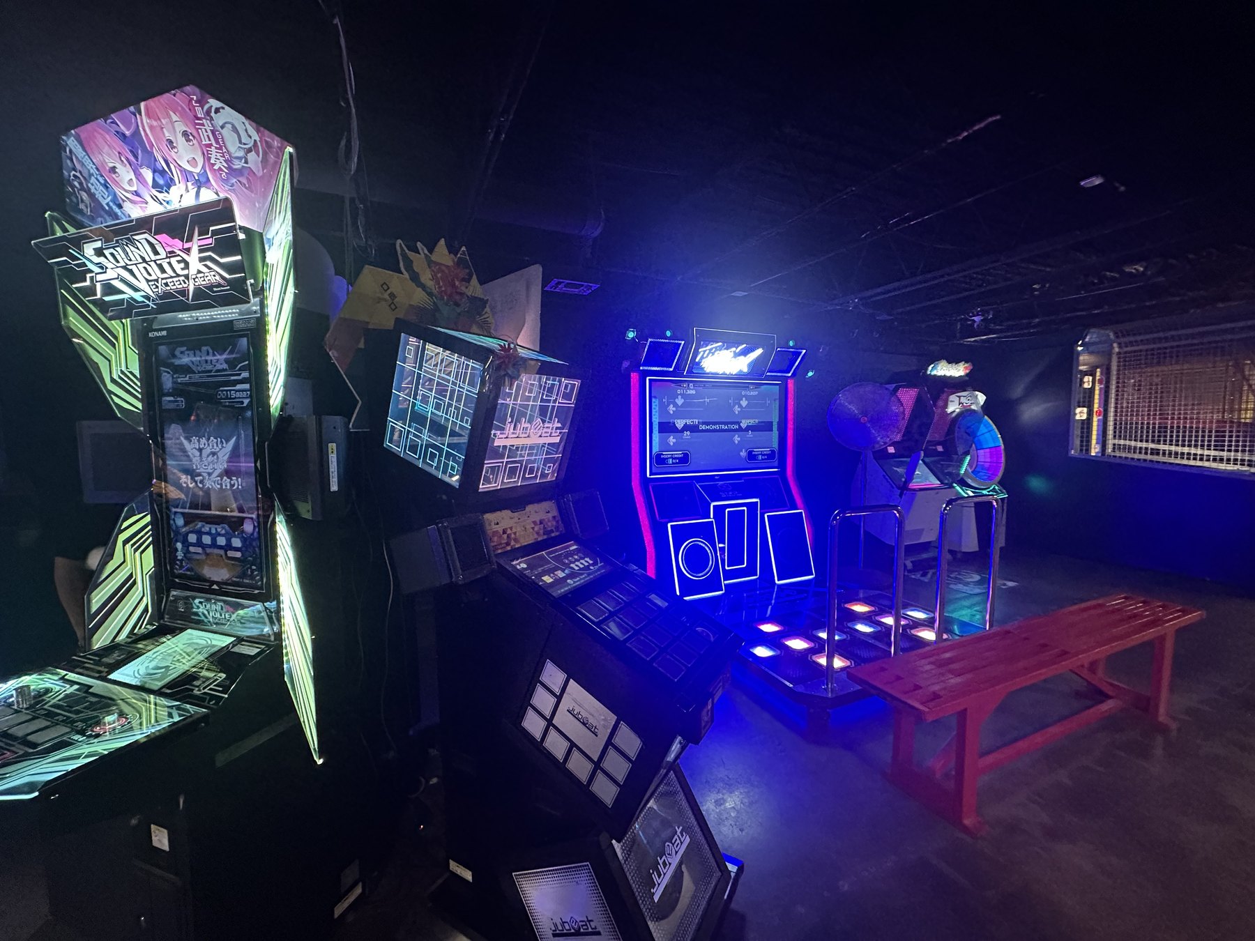 Neon rhythm games and music arcade machines glowing inside Cactus Jack’s in OKC.