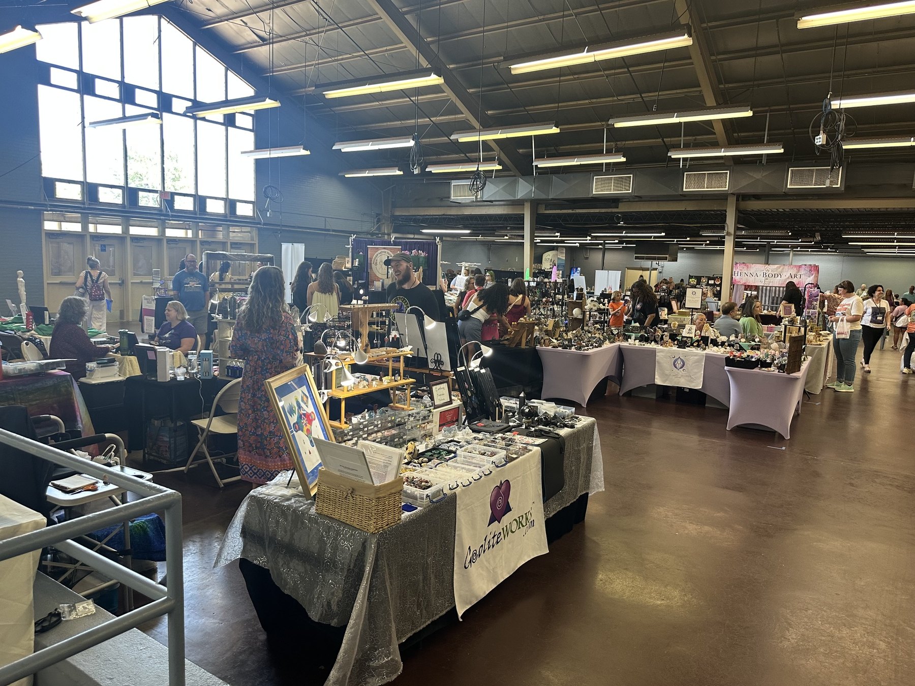Crystal, jewelry, and spiritual goods booths set up inside the Gypsy Soul Fair event hall.