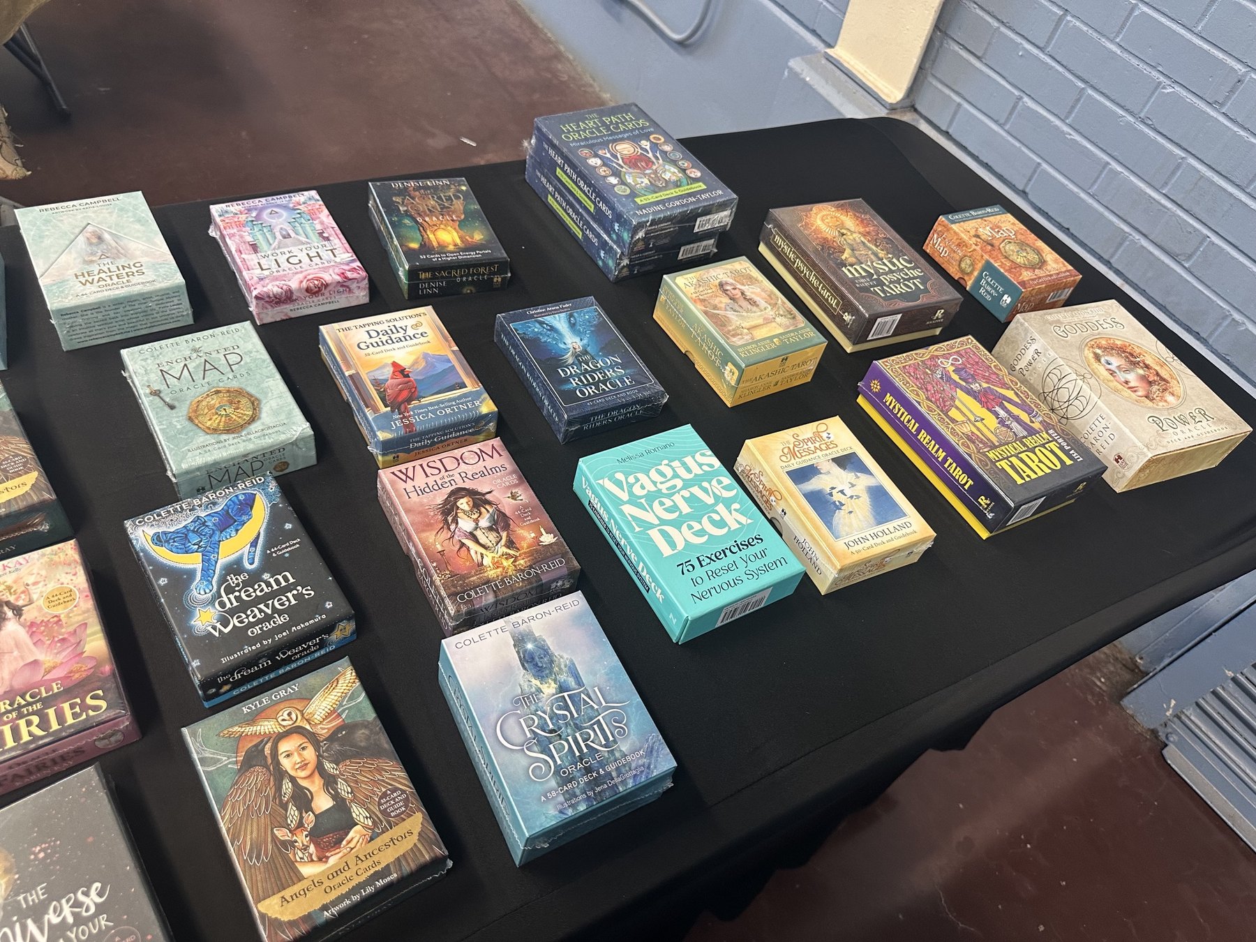 Tarot, oracle, and mindfulness card decks displayed on a vendor table at the Gypsy Soul Fair.