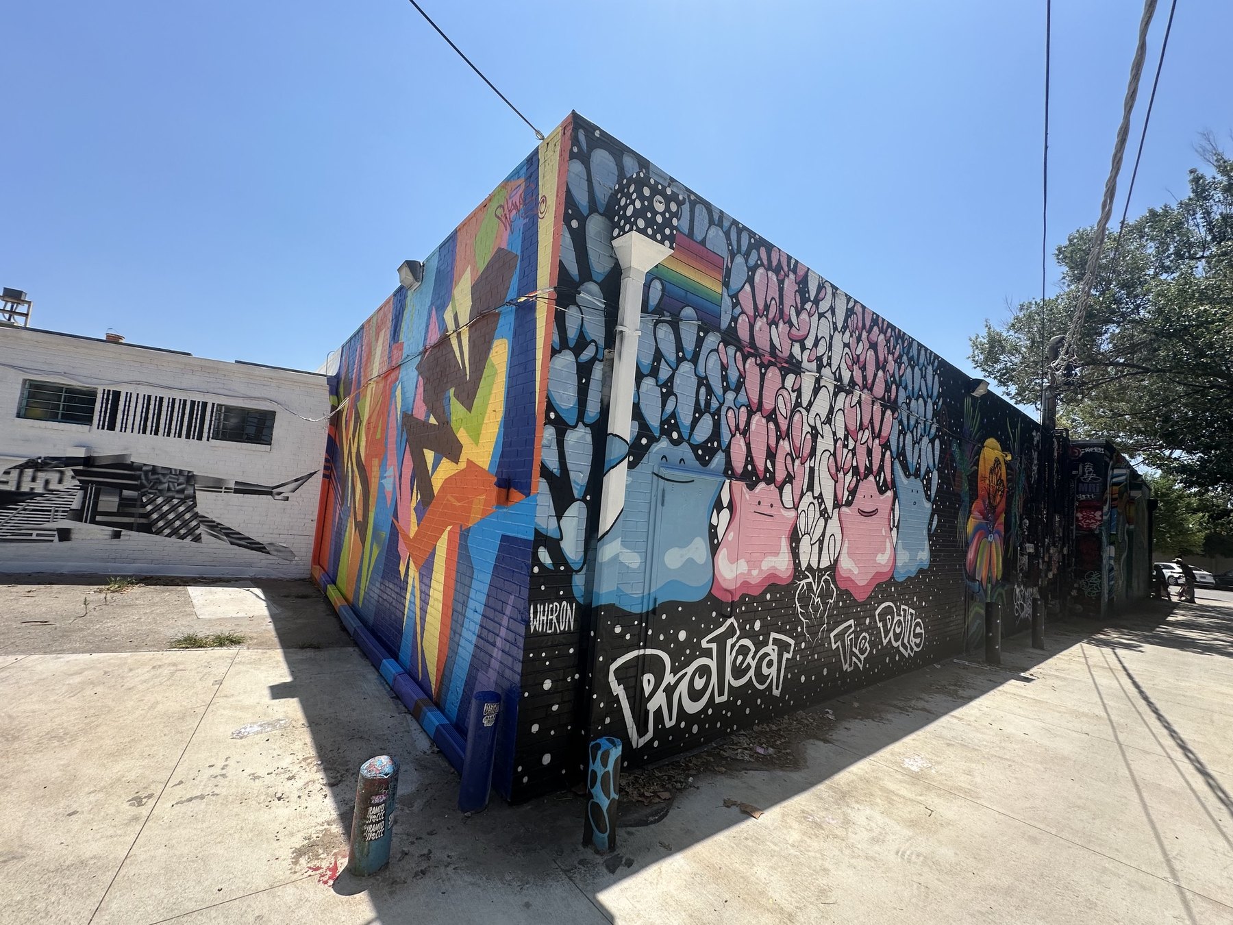 Colorful murals covering a corner building at Plaza Walls in Oklahoma City's Plaza District