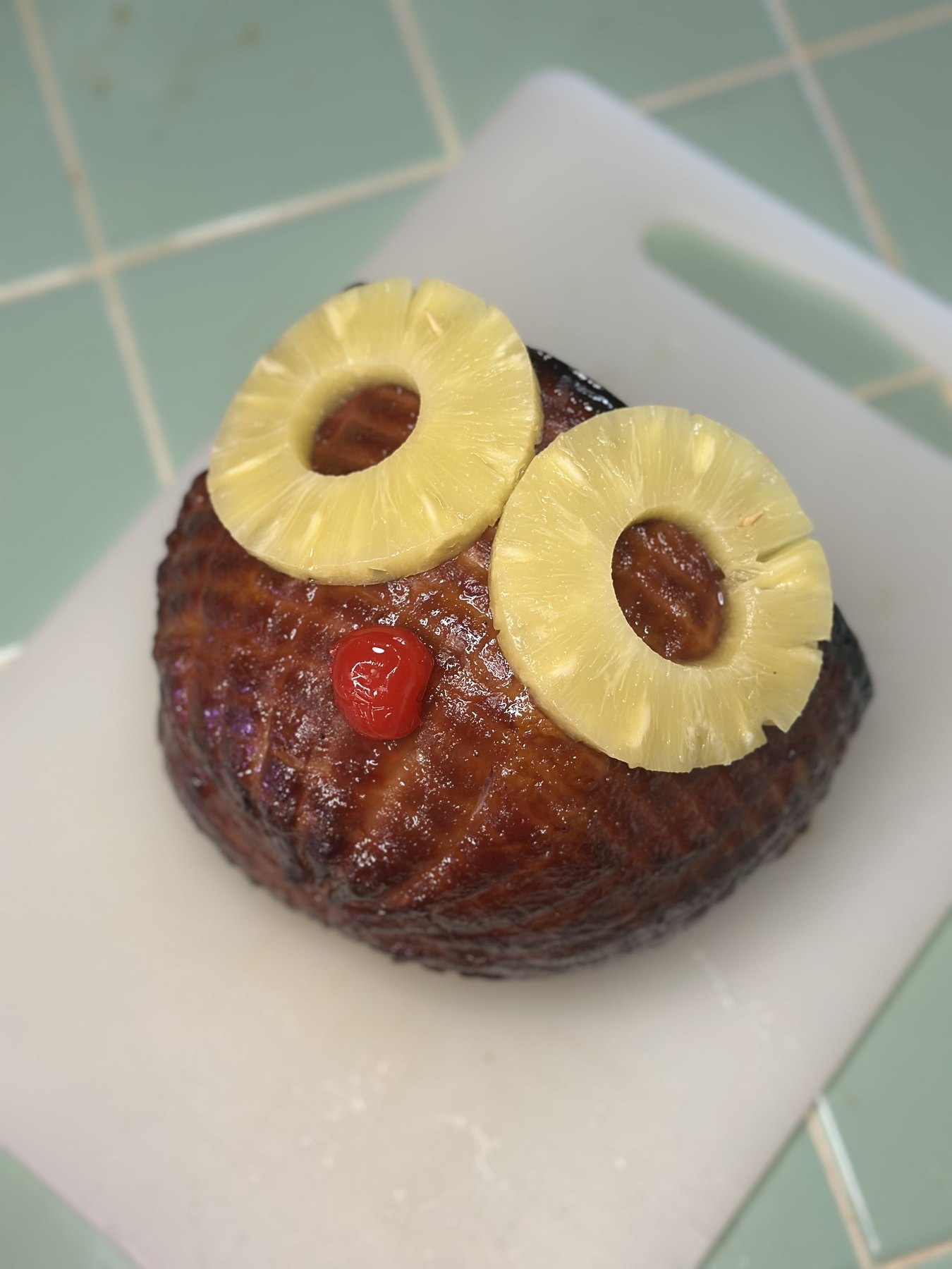 Finished Rum Ham glazed and decorated with pineapple rings and a maraschino cherry
