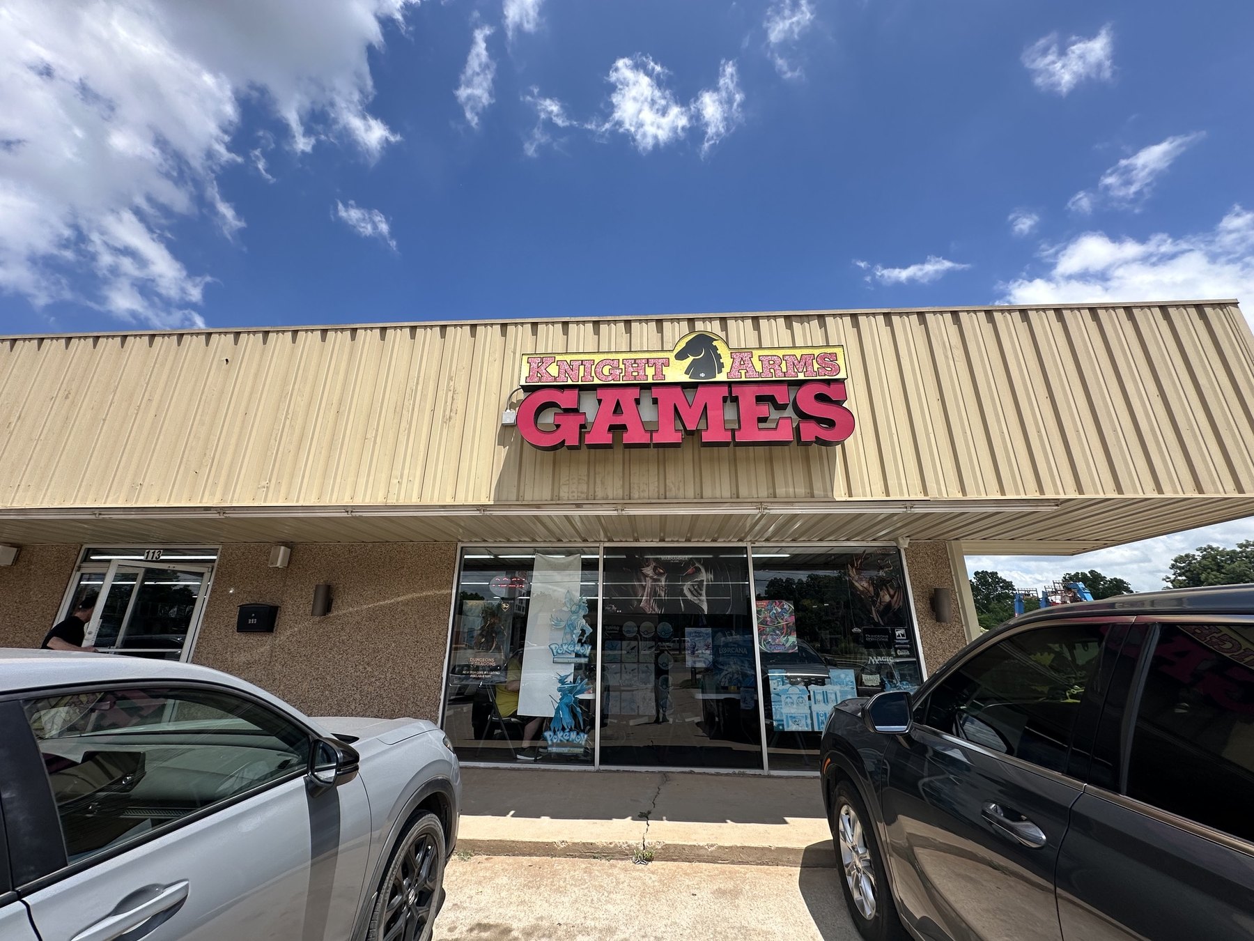 Exterior storefront sign for Knight Arms Games in Stillwater, Oklahoma