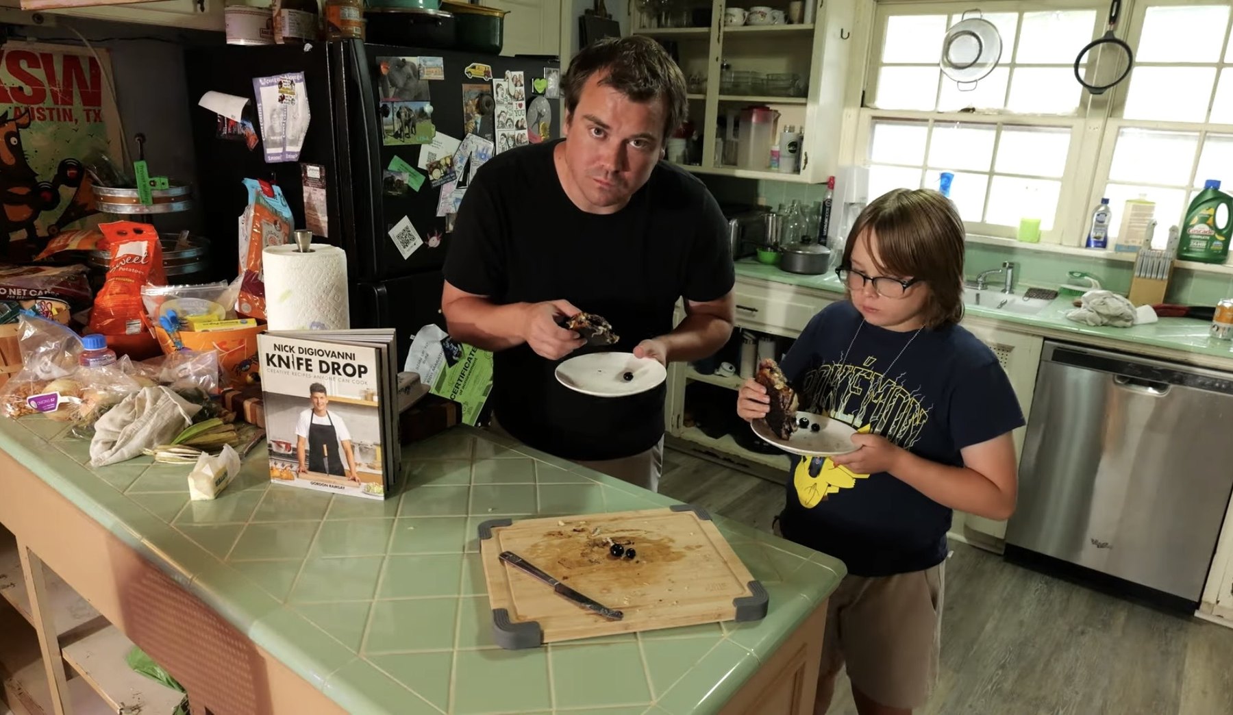 Adult and child taste blueberry brie grilled cheese in a home kitchen with the Knife Drop cookbook on the counter.