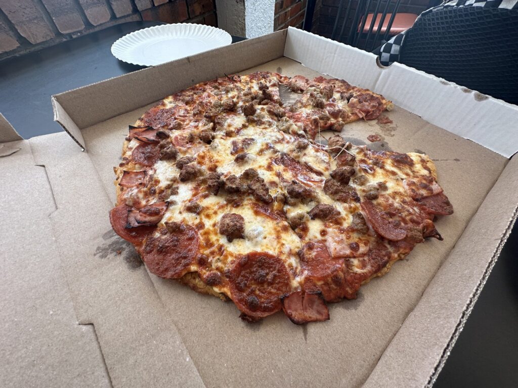 Meat-E-Orite pizza in a box at Pizza Shuttle in Norman, Oklahoma.