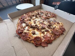 Meat-E-Orite pizza in a box at Pizza Shuttle in Norman, Oklahoma.