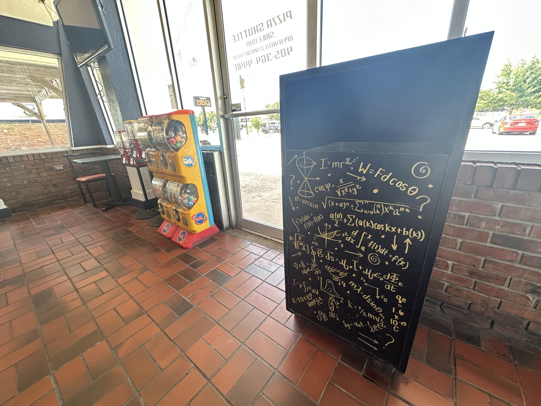 Painted trash can with science equations inside Pizza Shuttle in Norman, Oklahoma.