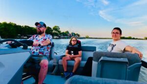 Family riding in a boat on Arcadia Lake in Oklahoma during a summer evening.