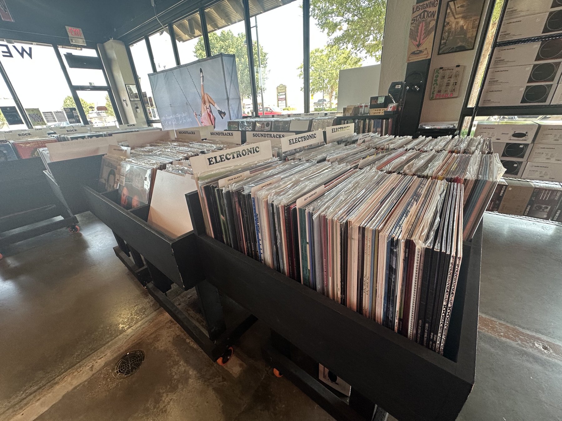 Vinyl bins labeled Electronic and Soundtracks inside Guestroom Records Edmond.