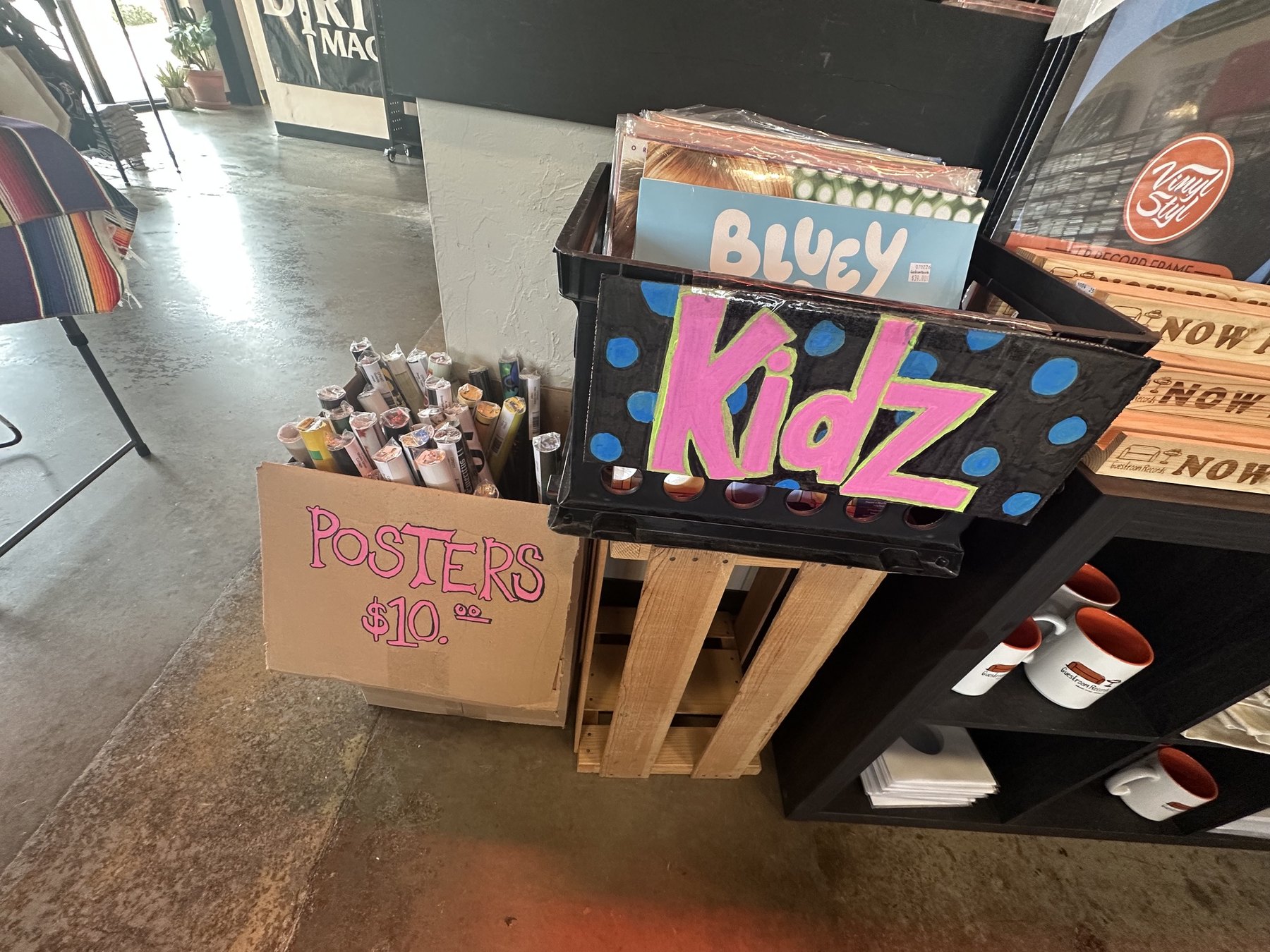Kids records and poster rolls on display at Guestroom Records in Edmond.