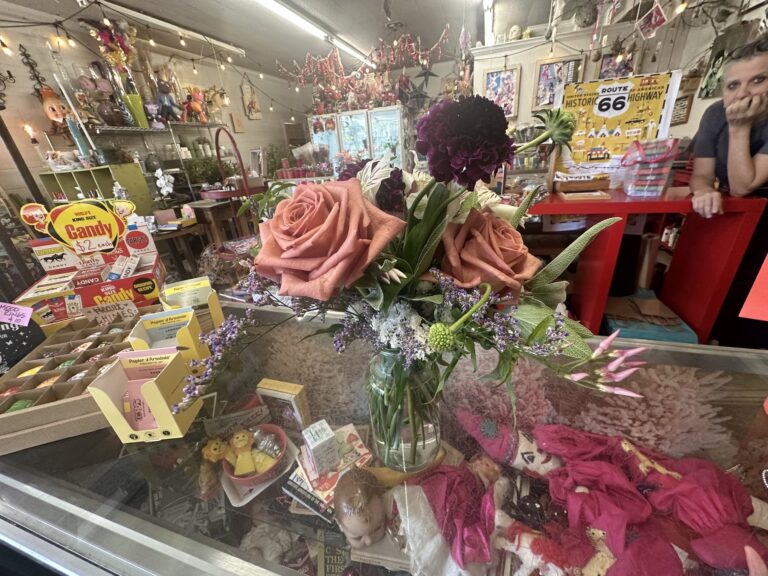 Fresh floral arrangement with pink roses on the counter inside A Date With Iris in Oklahoma City.