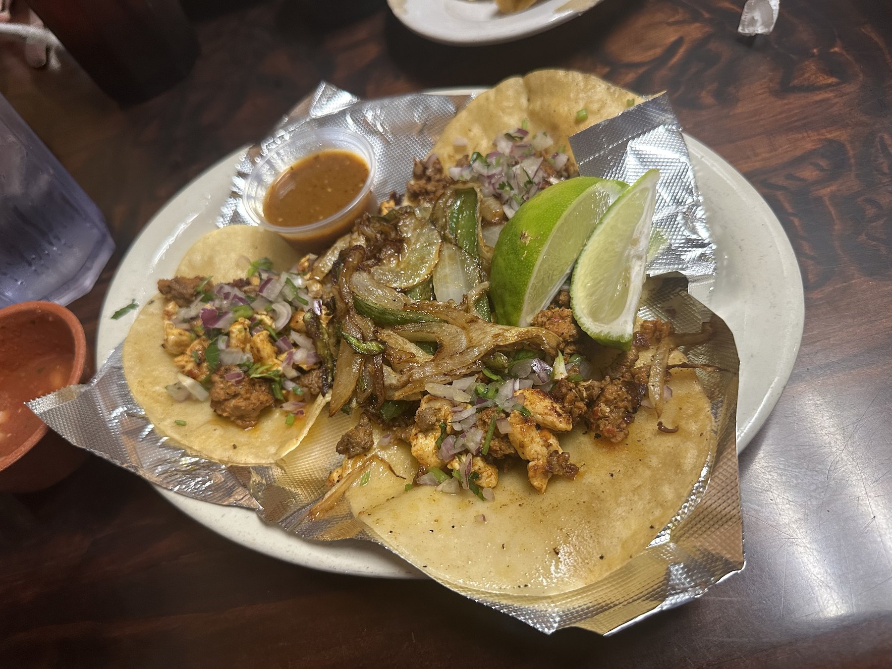 Street tacos with grilled onions, lime wedges, cilantro, and salsa at Los Potros Mexican Restaurant in Blackwell, Oklahoma.