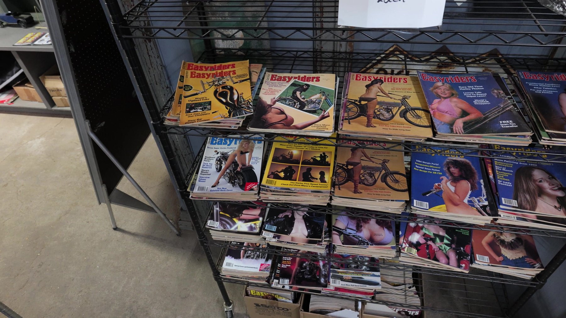 Vintage motorcycle magazines displayed on a rack at Seaba Station Motorcycle Museum.