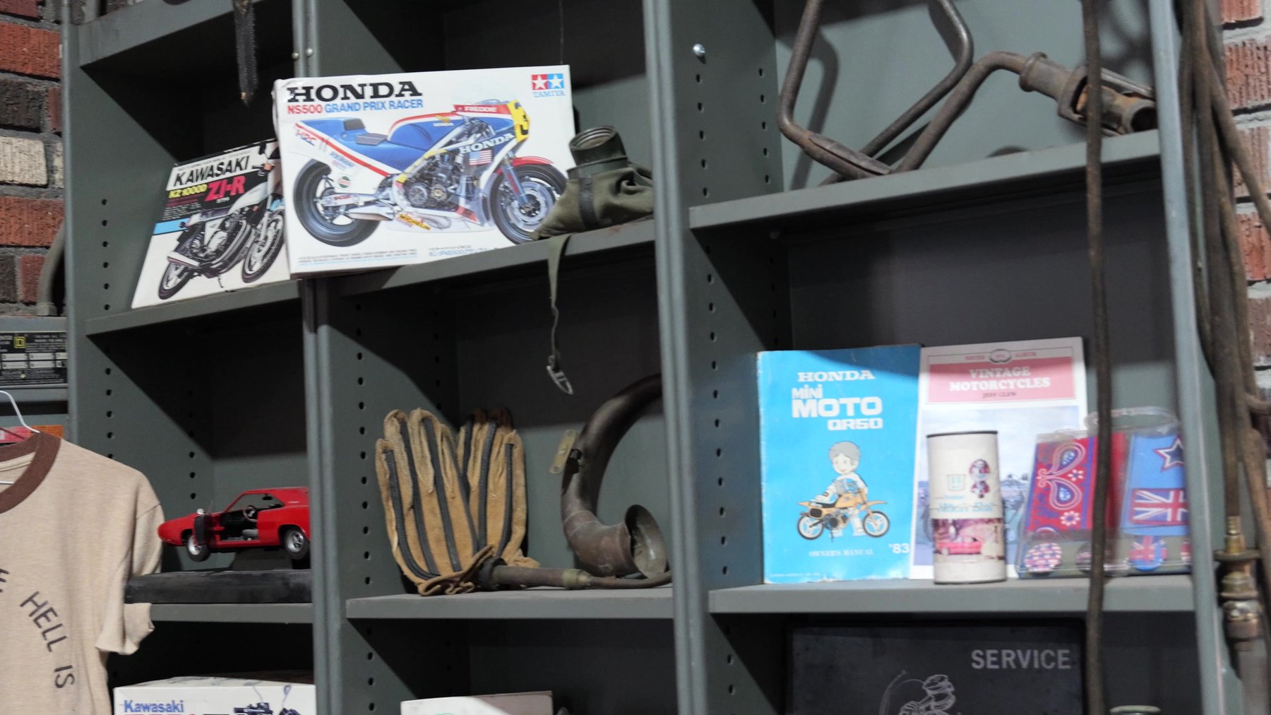 Motorcycle model kits, manuals, parts, and memorabilia displayed on shelves at Seaba Station Motorcycle Museum.
