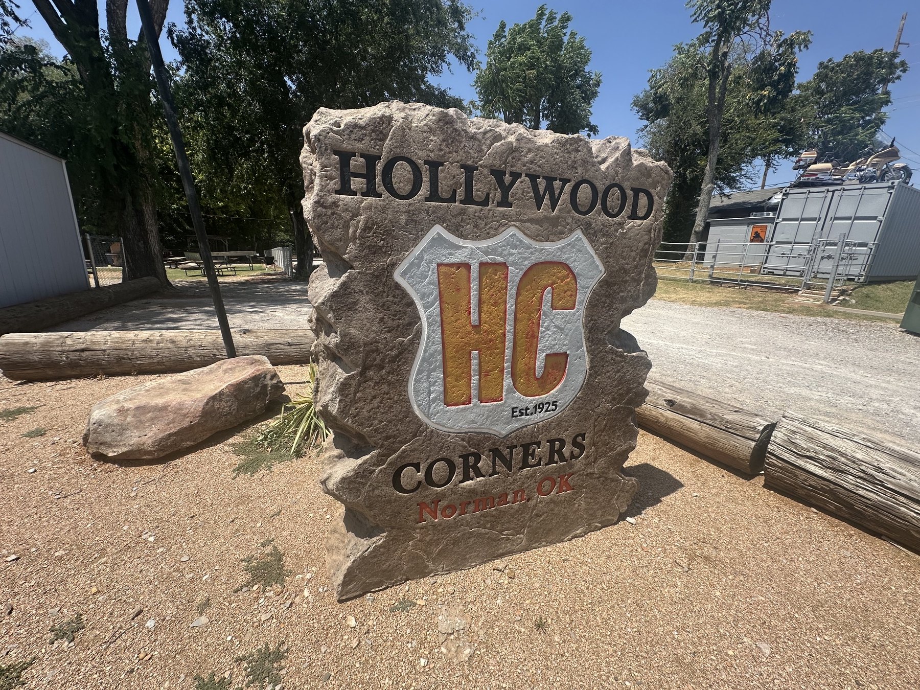 Stone Hollywood Corners sign with HC logo and Norman OK text.