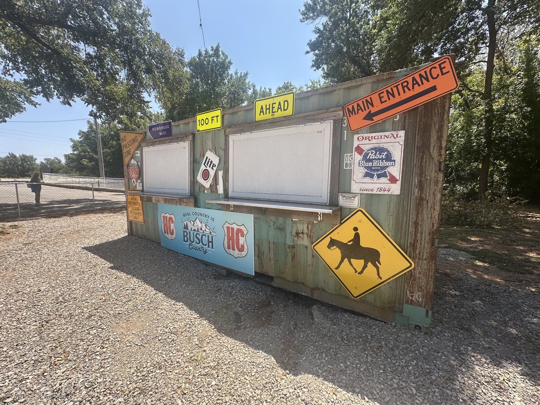 Rustic Hollywood Corners entrance area with a Main Entrance sign and vintage-style notices.