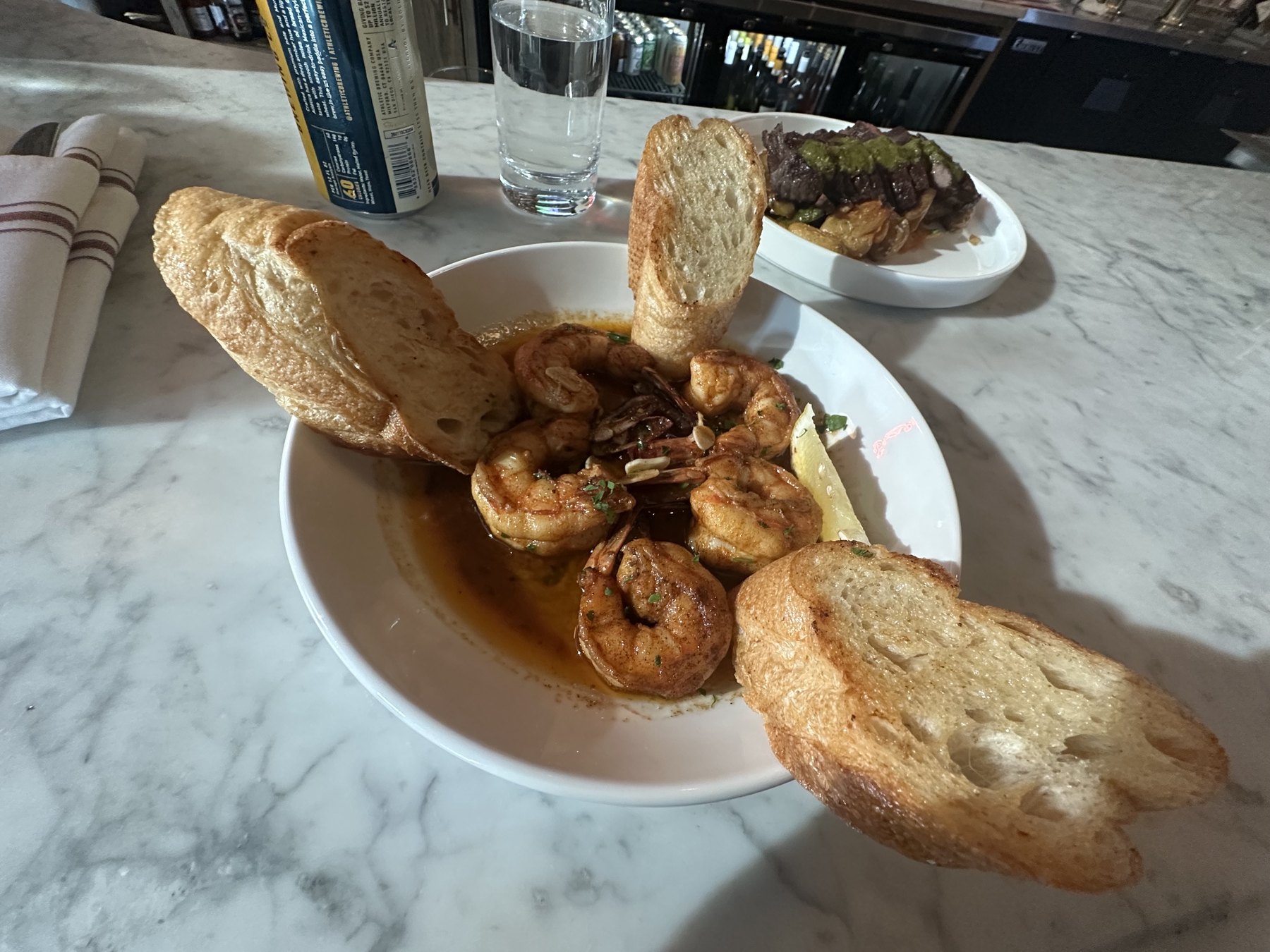 Shrimp in garlic sauce with toasted bread at Red Rooster in Oklahoma City's Paseo District