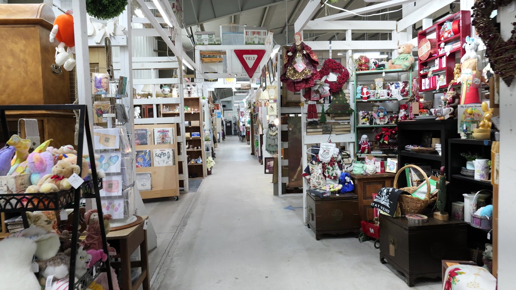 Long aisle of furniture, toys, books, and collectibles at The Rink Gallery in Bethany, Oklahoma.