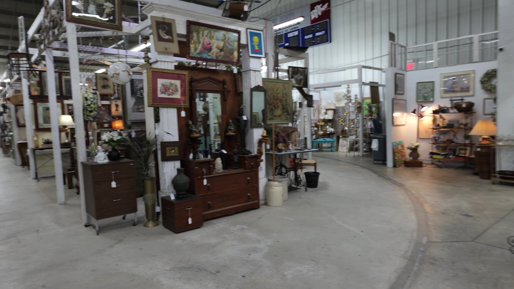 Antique dressers, mirrors, lamps, and art inside The Rink Gallery in Bethany, Oklahoma.
