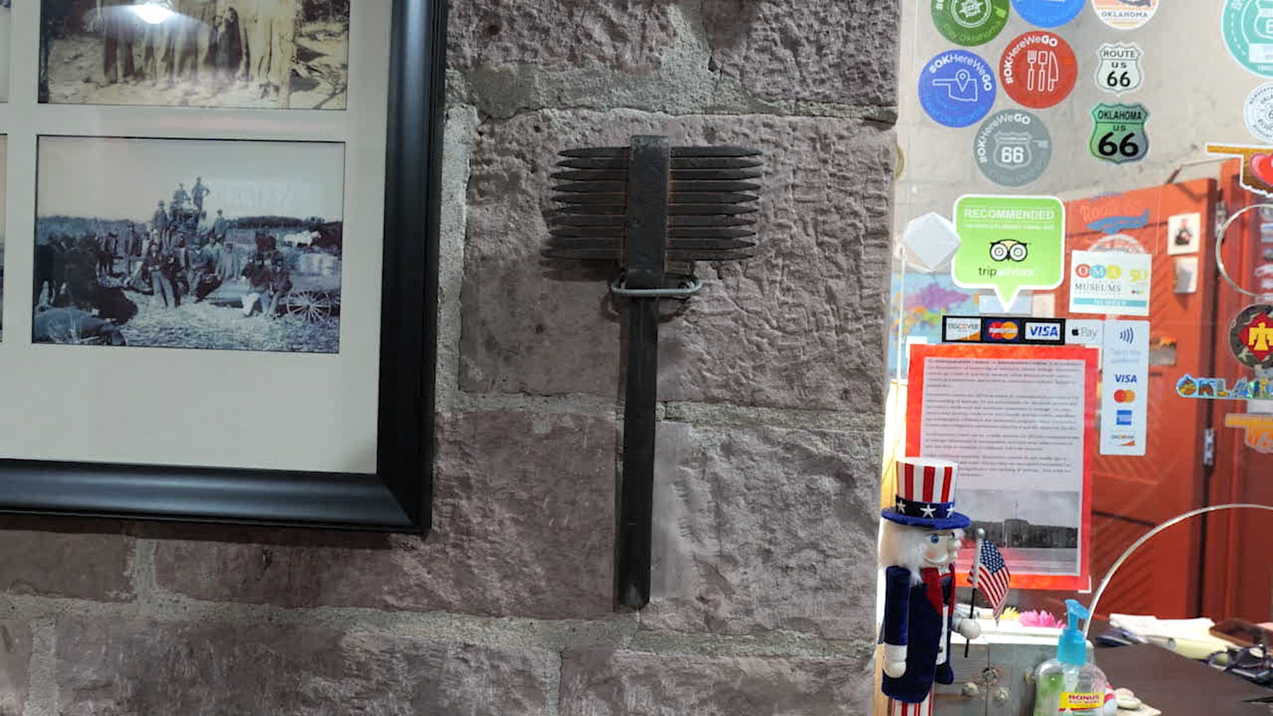 Historic stone wall and display inside the Route 66 Interpretive Center showing armory craftsmanship