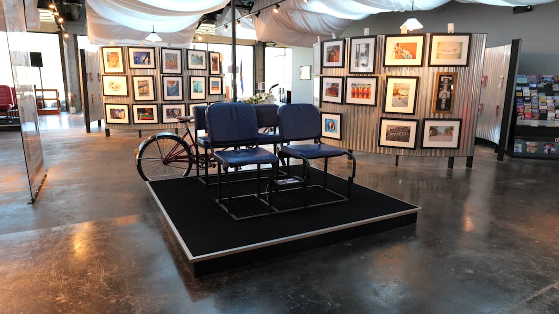 Vintage vehicle seating and artwork inside the Route 66 Interpretive Center gallery