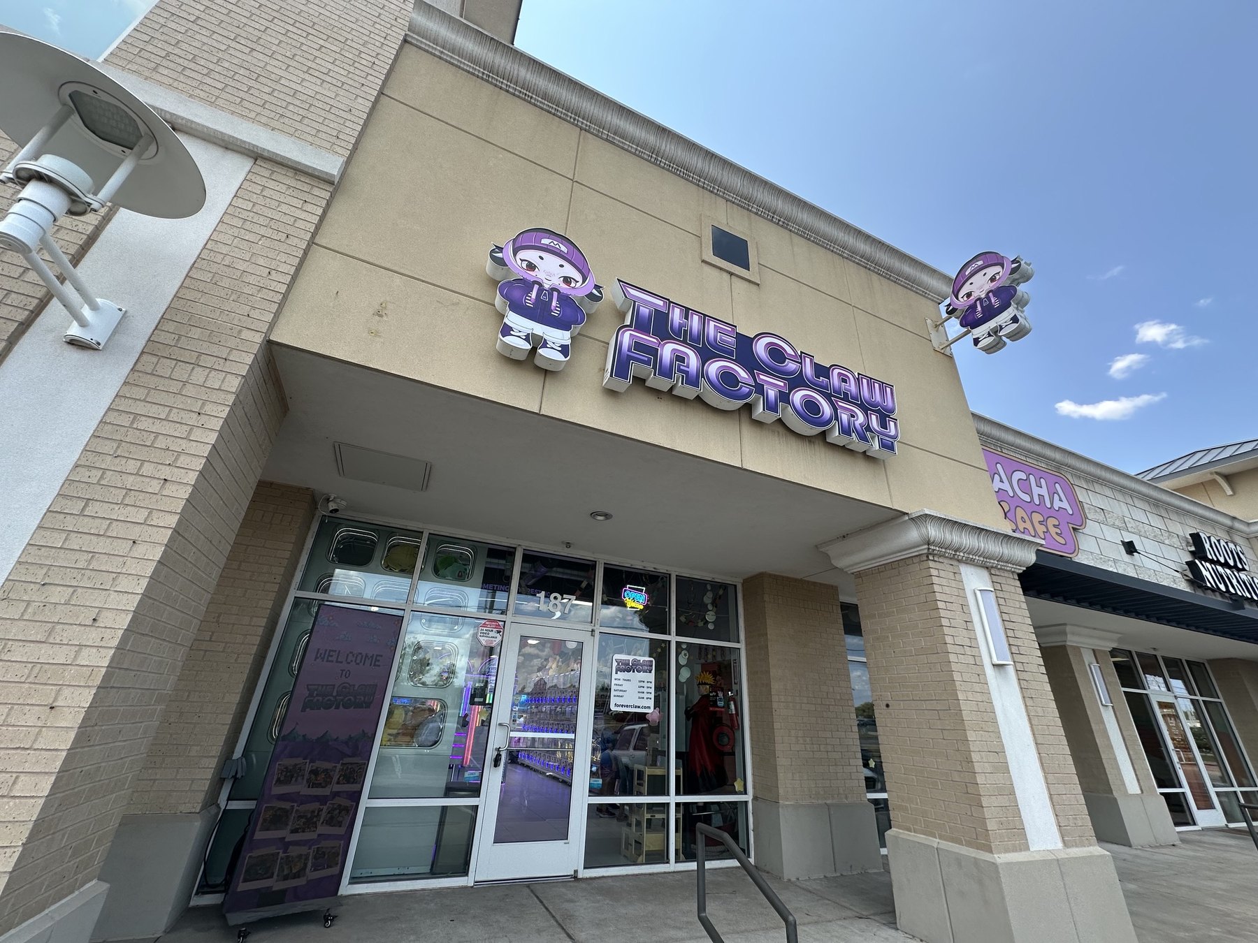 Exterior storefront sign for The Claw Factory in Edmond, Oklahoma.