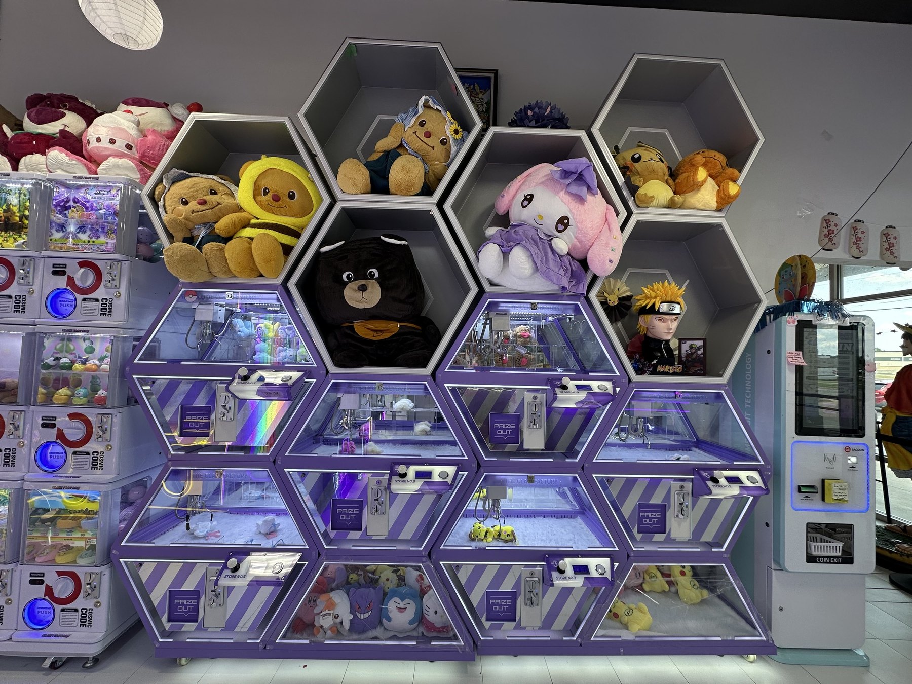 Honeycomb-shaped claw machines and plush displays at The Claw Factory in Edmond.