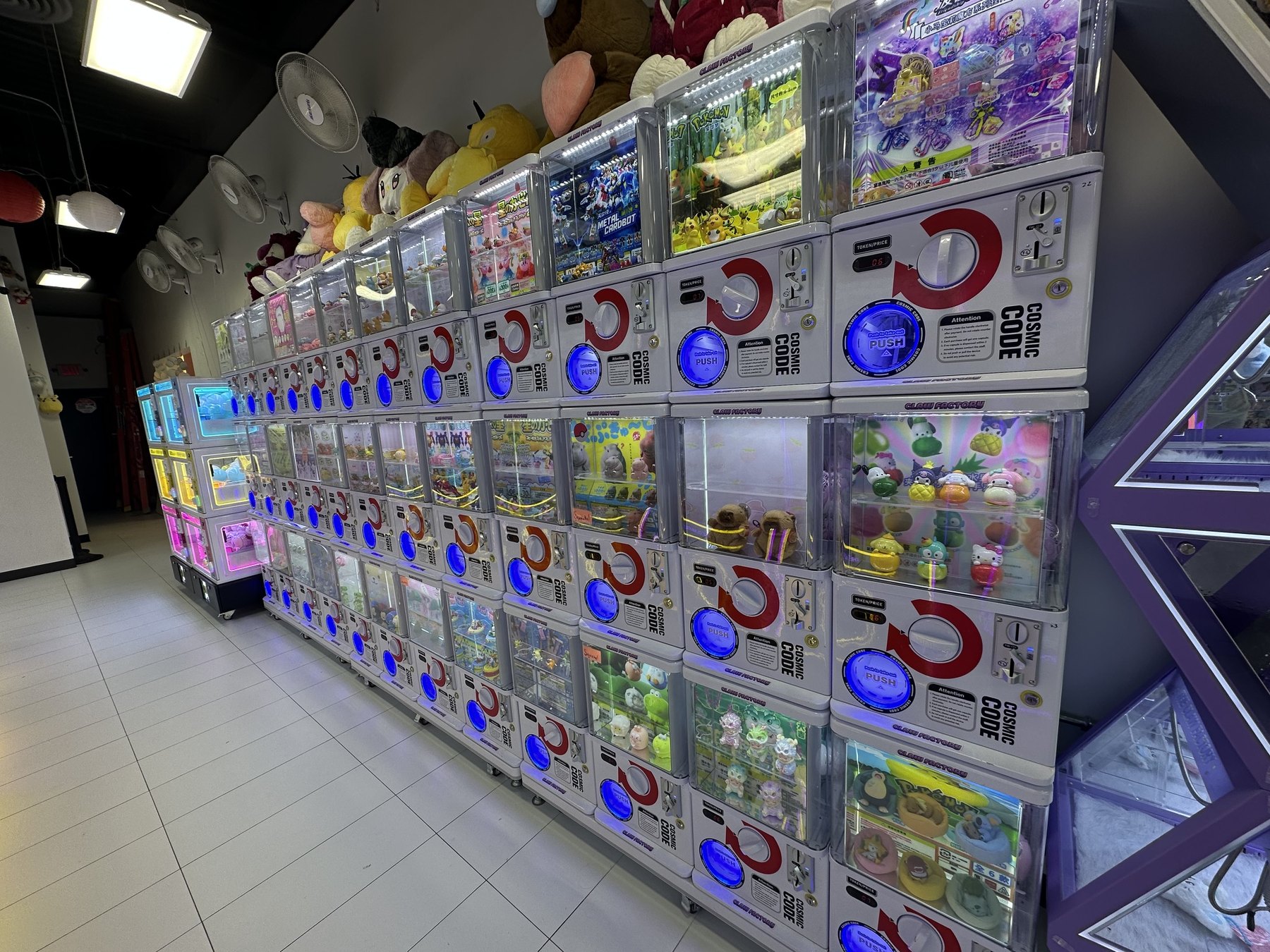 Long wall of capsule toy machines inside The Claw Factory in Edmond.