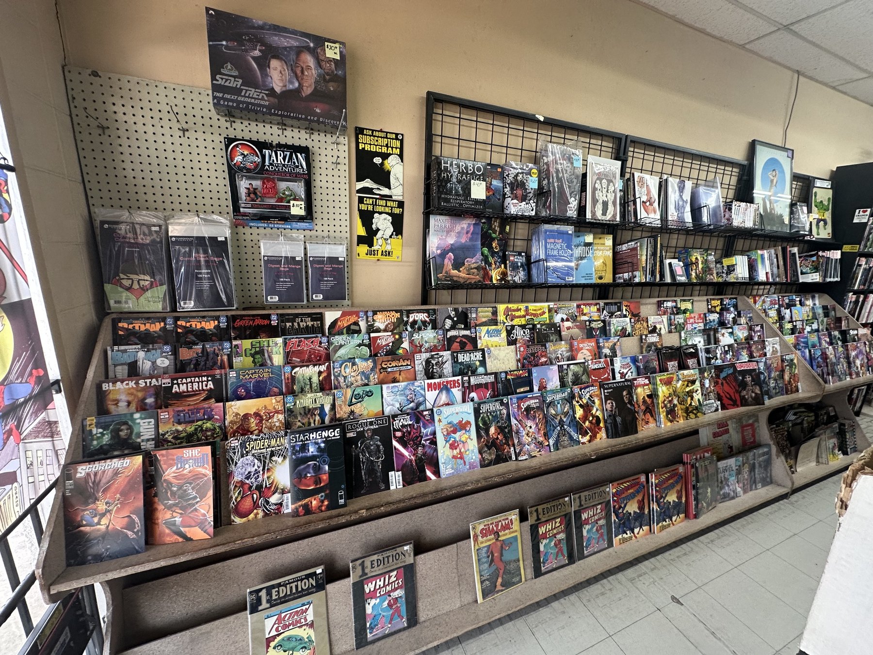 Wall display of comics and graphic novels inside The Comic Empire in Tulsa
