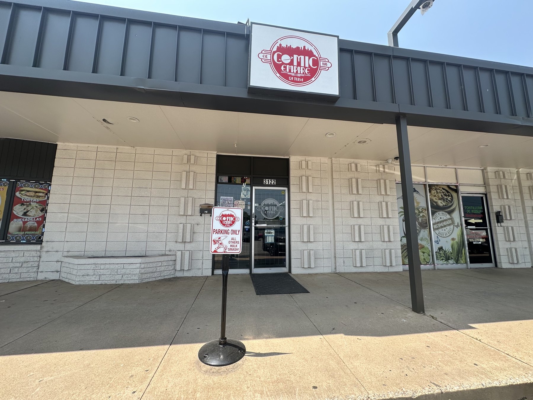 Exterior storefront sign for The Comic Empire in Tulsa
