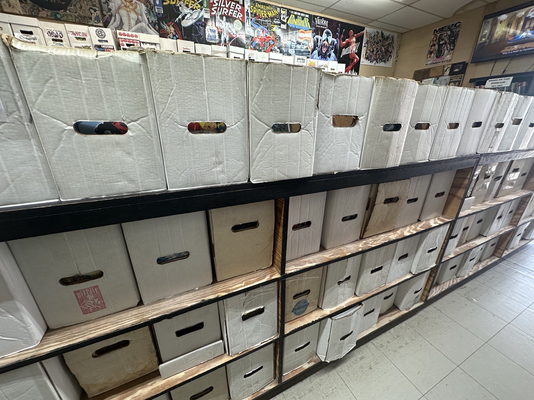 Shelves of organized comic storage boxes inside The Comic Empire in Tulsa