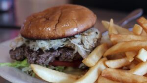 Burger with grilled toppings and fries at The Rock Cafe in Stroud, Oklahoma